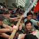 Pro-democracy activists scuffle with police officers outside the Hong Kong Conventional center to protest the visit of Chinese Foreign Minister Qian Qichen Friday, Nov. 15, 1996. The protesters said that Qian was the harbinger of "illegal" changes to Hong Kong 's political system. Qian convenes a meeting of 400 Hong Kong people who will choose the post-handover chief-executive in what pro-democracy activists say is a secretive and unfair process. (AP Photo/Vincent Yu)